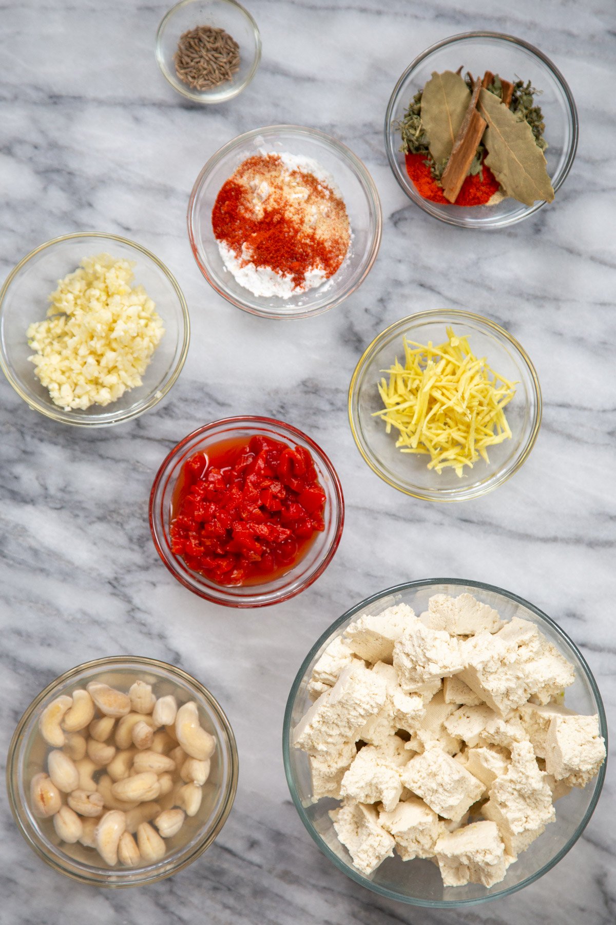 ingredients needed for making Indian Lasooni Chicken on a marble counter