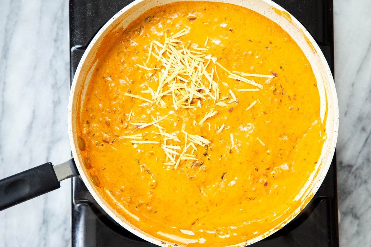 creamy red bell pepper gravy in a sauteeing pan
