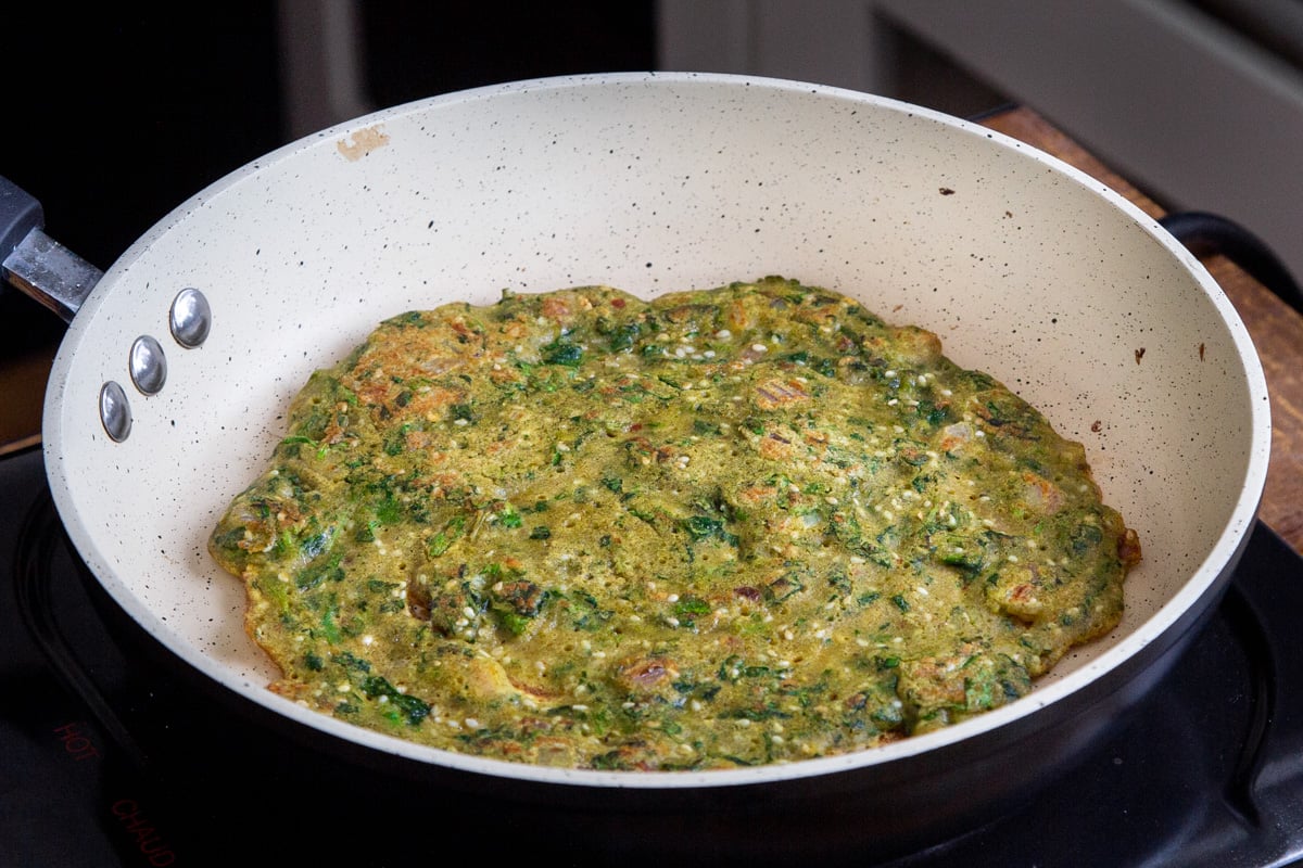 vegan lentil flour pancake in a frying pan
