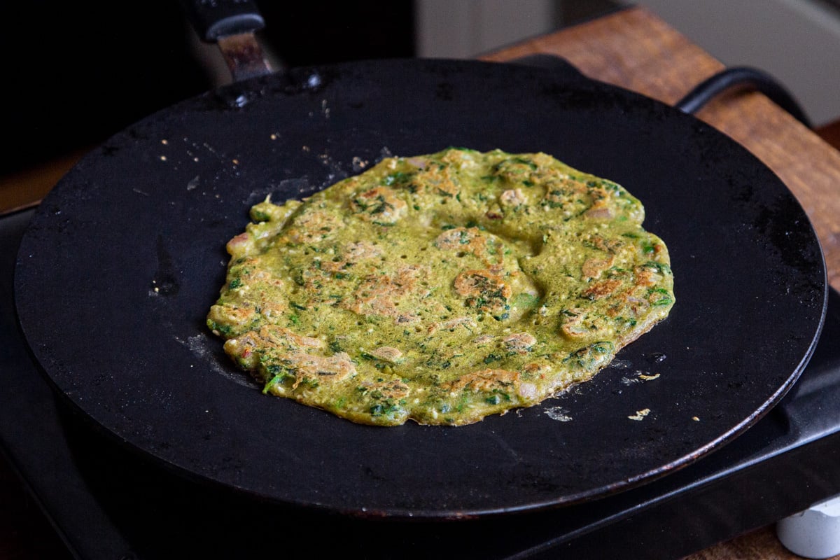 freshly baked vegan lentil pancake in a black skillet
