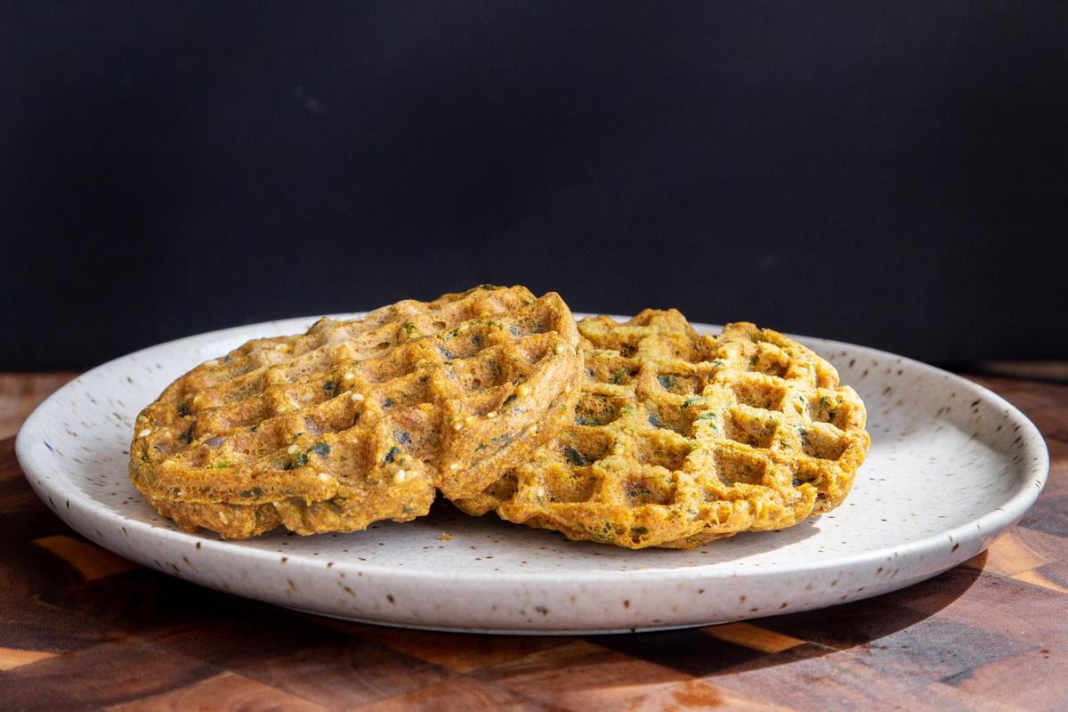 two lentil waffles on a white plate