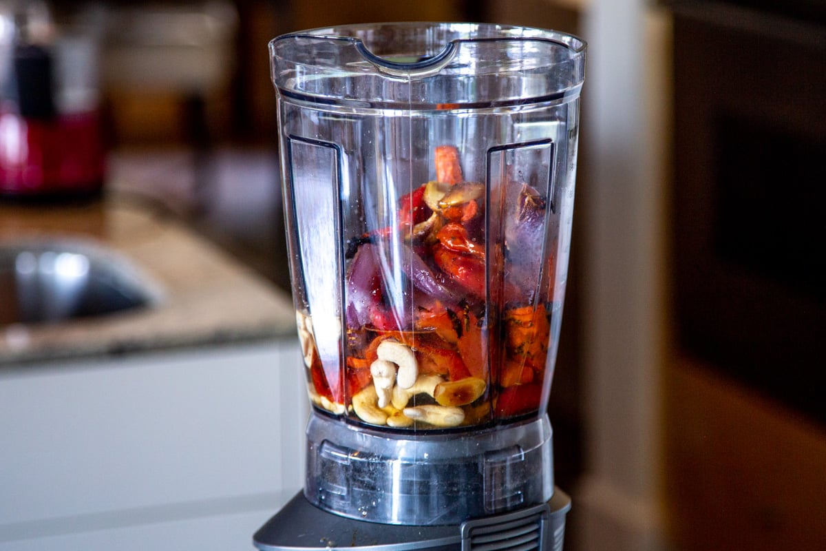 ingredients for vegan tomato soup in a tall blender