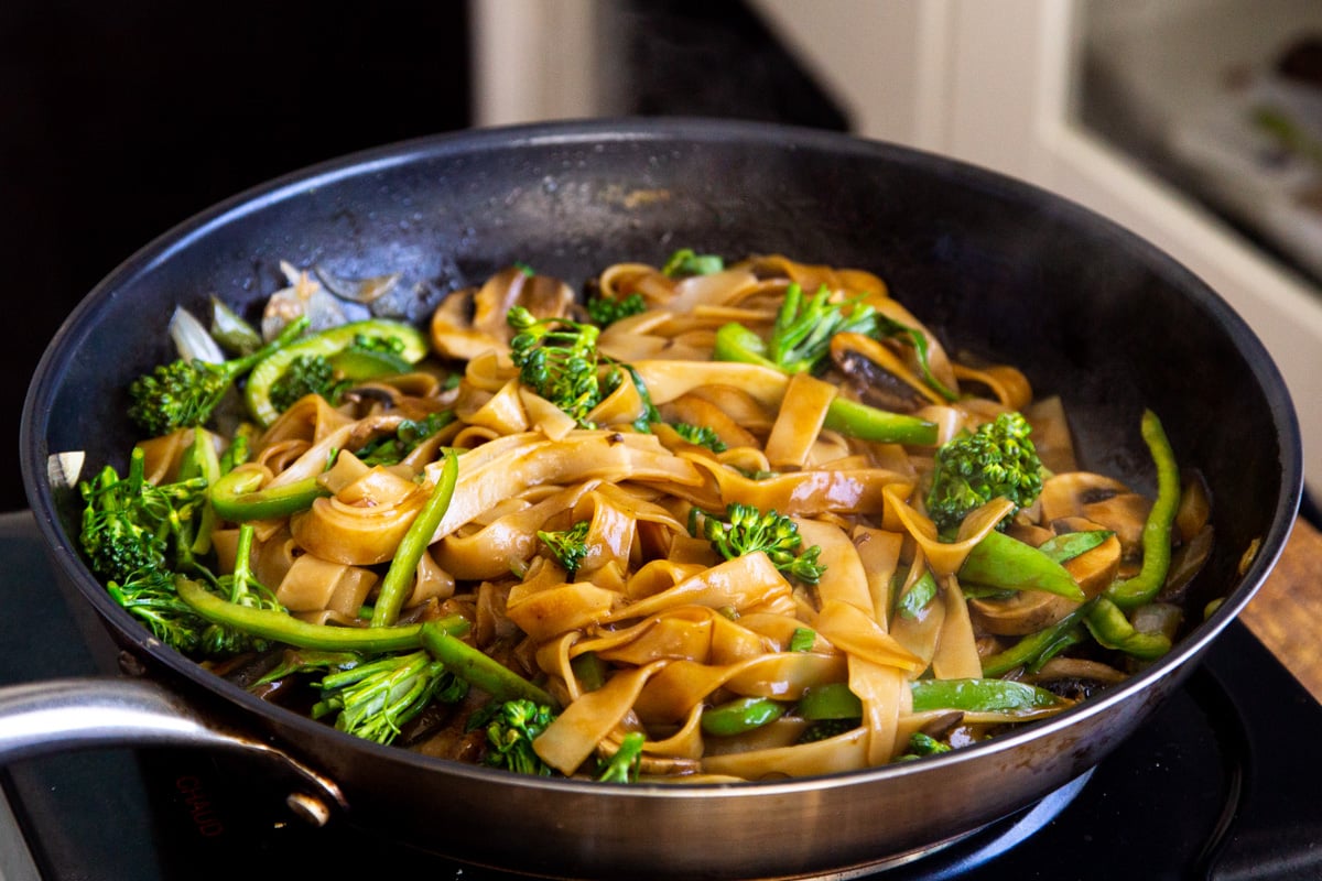 Thai Skillet Noodles with broccoli in a black skillet