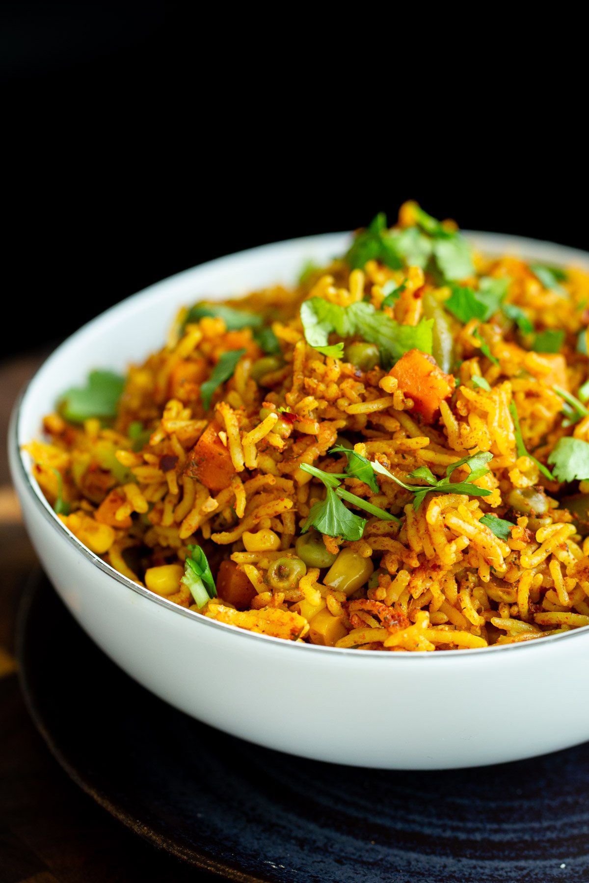 a white bowl with vegan baked masala rice casserole