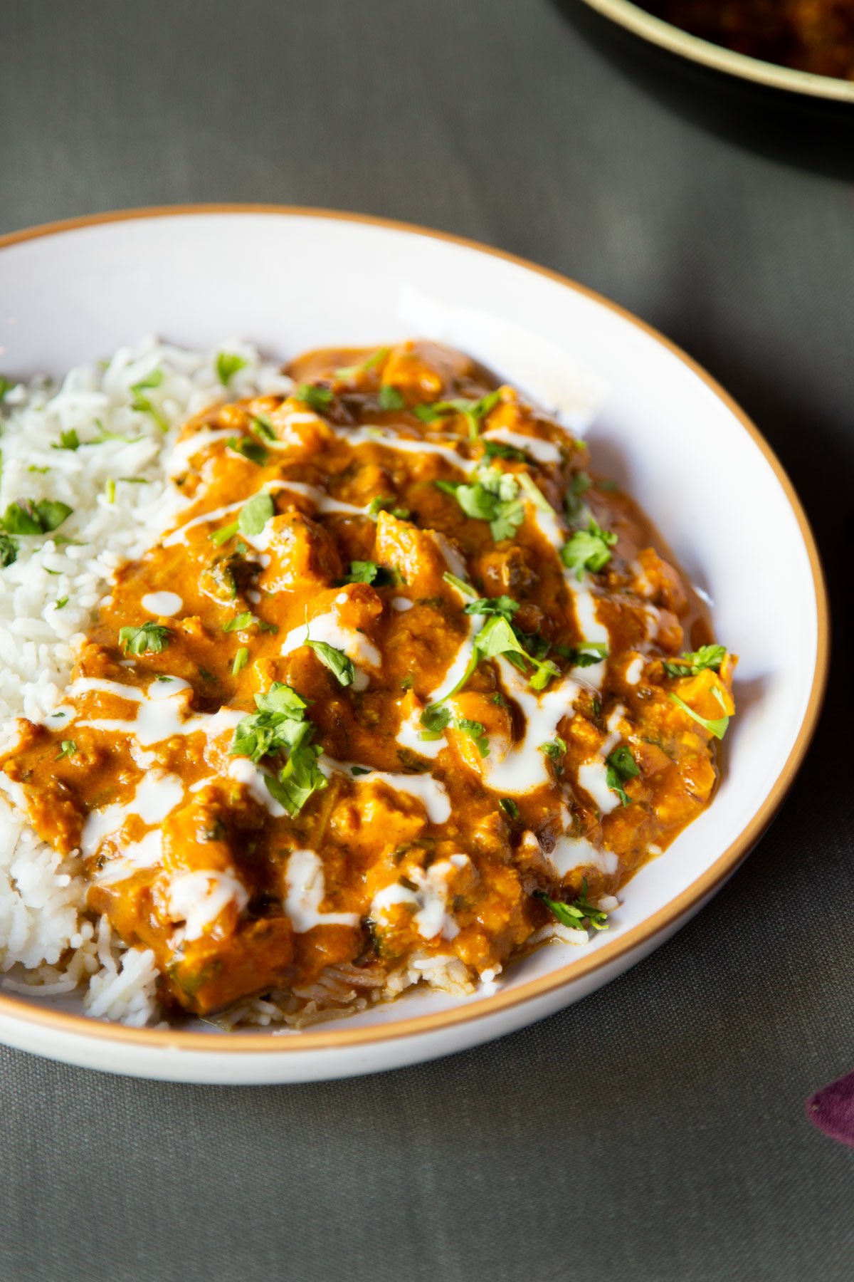 a plate with vegan balti chicken with a side of rice