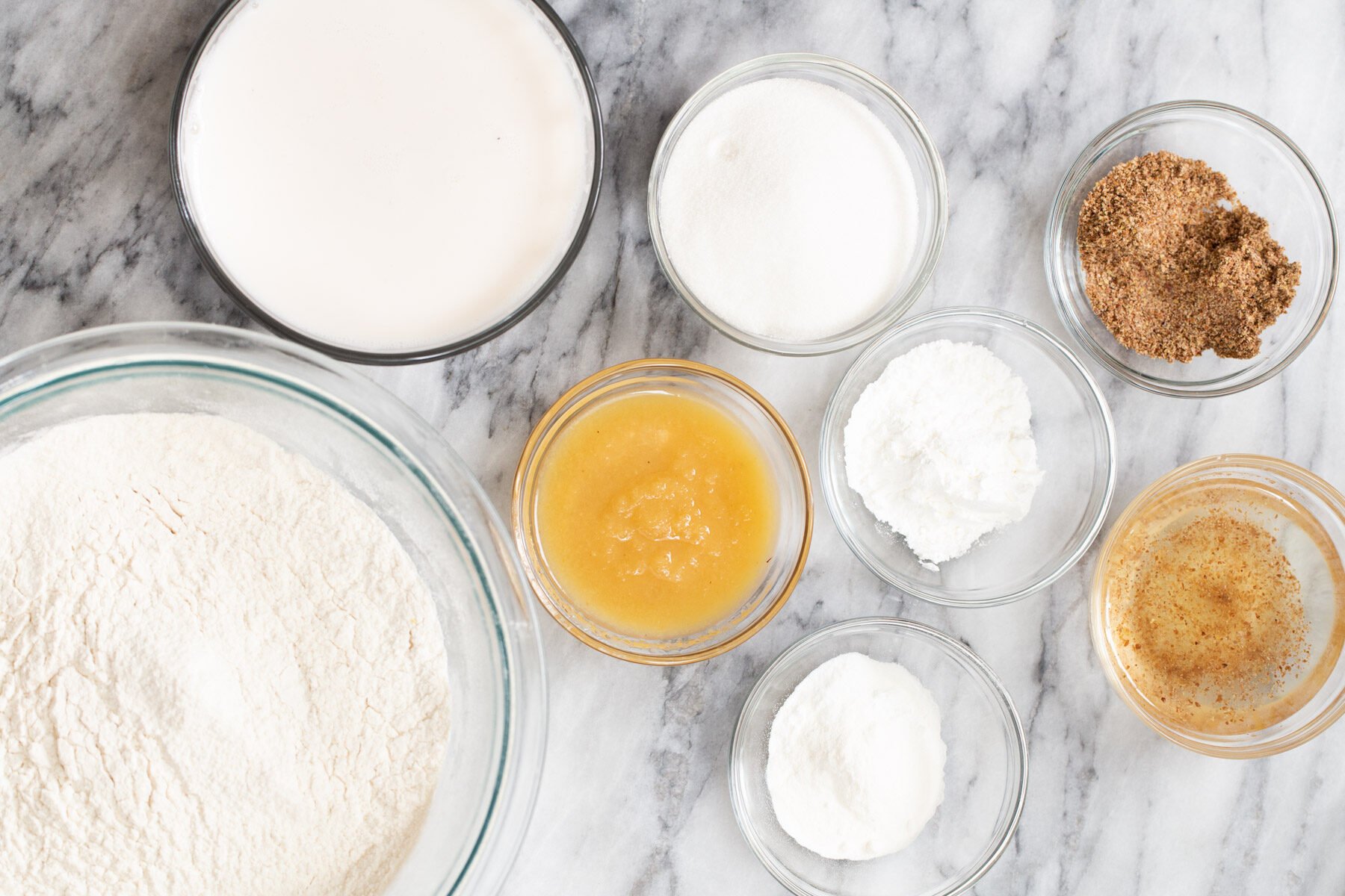 ingredients for making vegan sponge cake on a marble countertop
