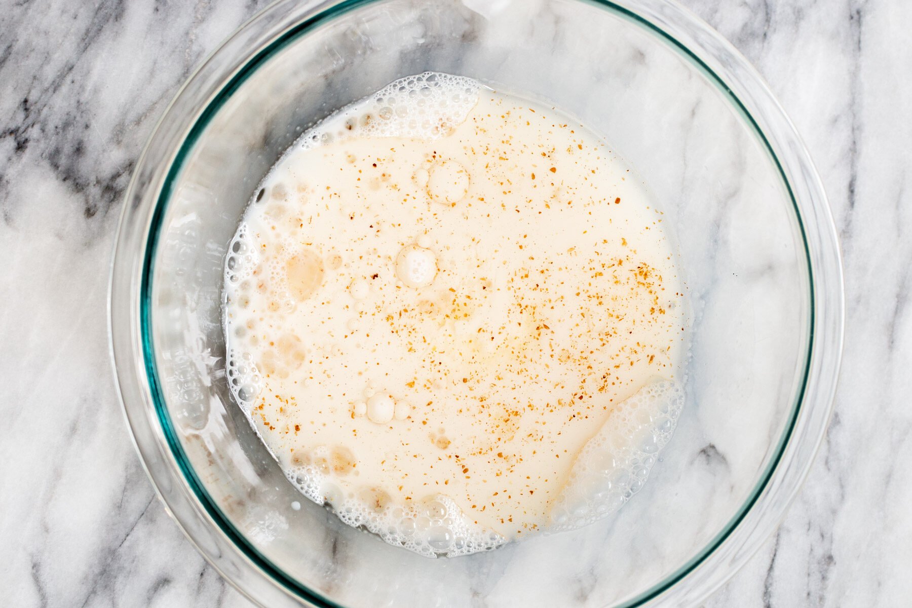 liquid ingredients for vegan boston cream pie cake in a glass bowl