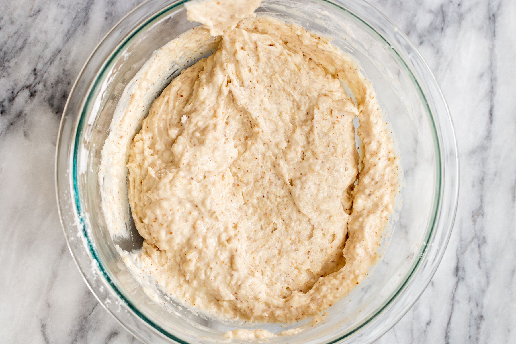 mixed cake batter ingredients in a glass bowl