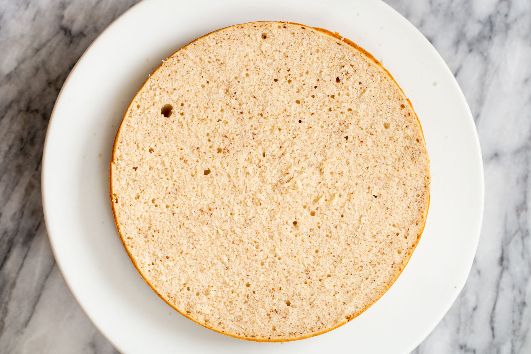 sliced open sponge cake on a cake stand