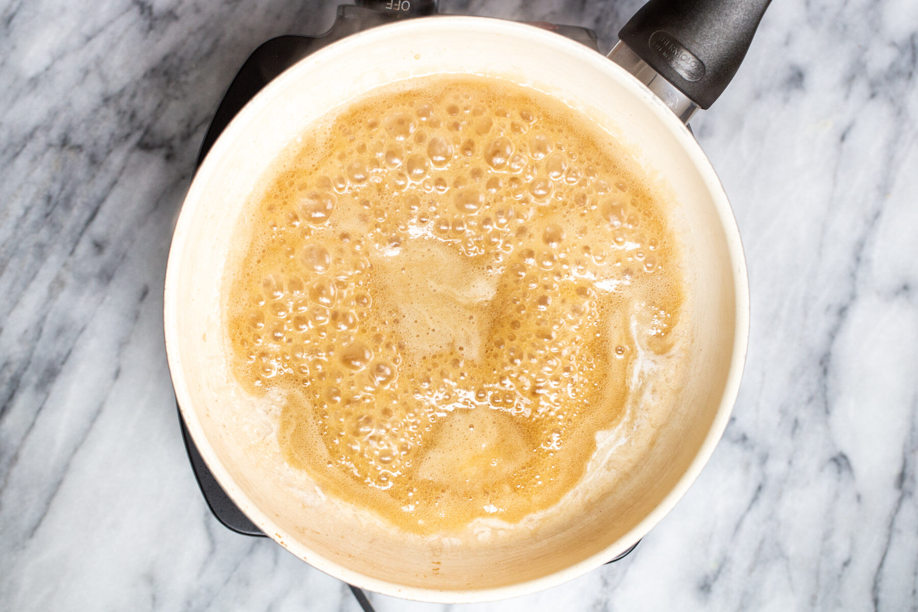 maple syrup and melted coconut cream simmering in a pan