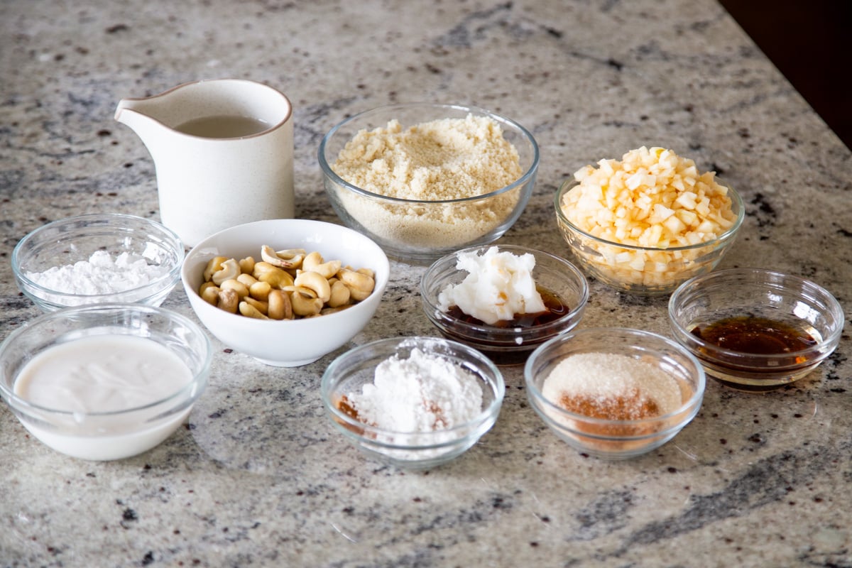 ingredients for vegan apple pie cheesecakes on a marble countertop