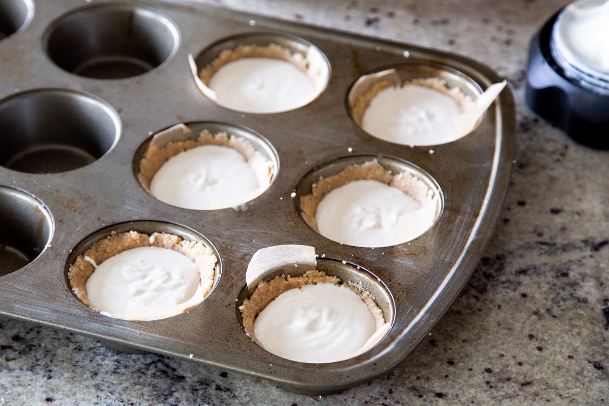 vegan mini cheesecakes in a metal muffin tin ready for making