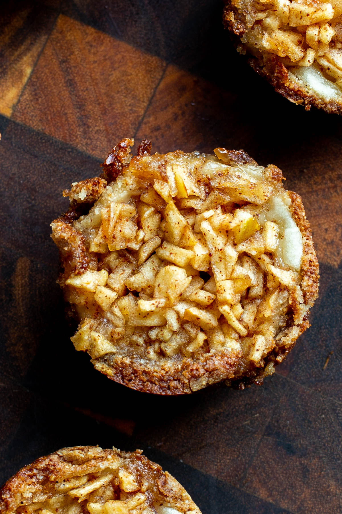 overhead shot of mini vegan apple pies on a wooden board