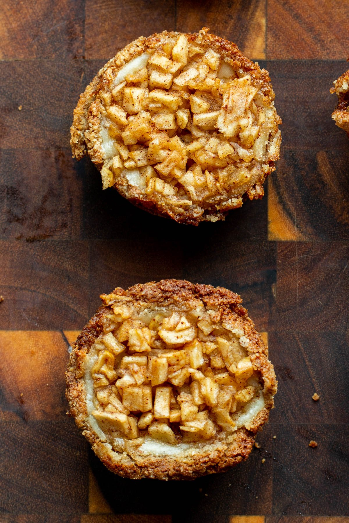 mini vegan apple cheesecakes on a wooden board