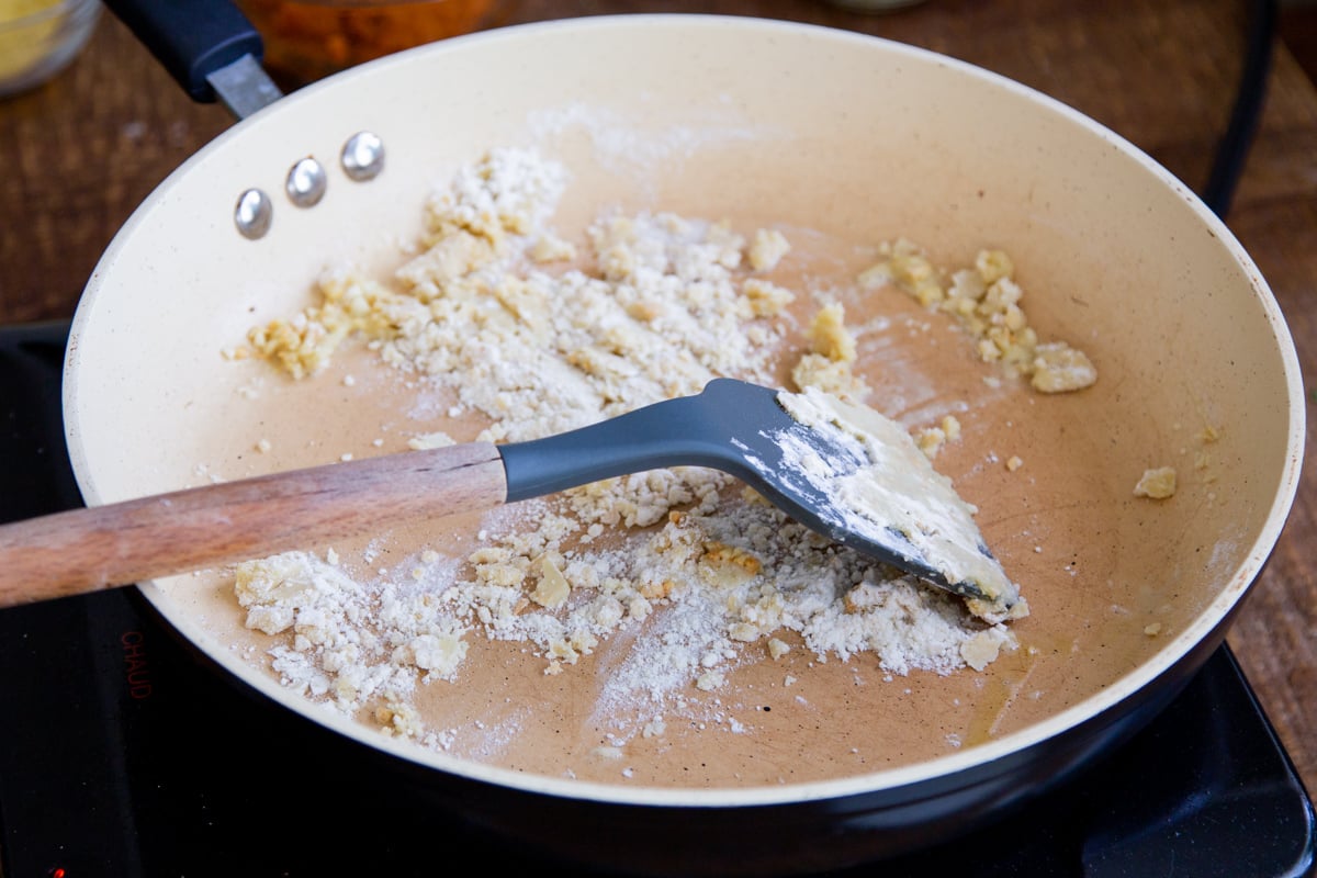 adding flour to the sautéed garlic