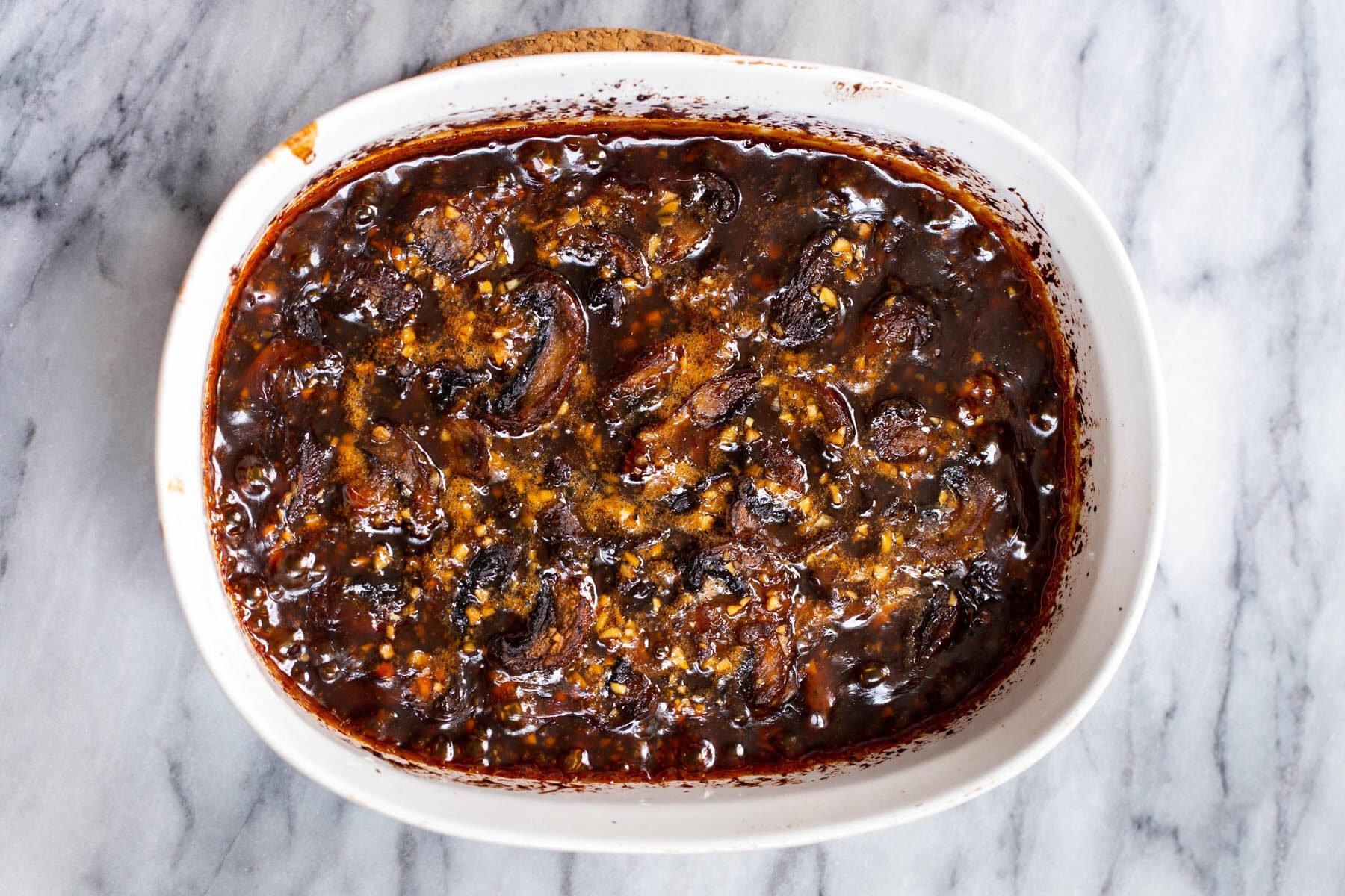 casserole dish with sliced sticky seasme mushrooms