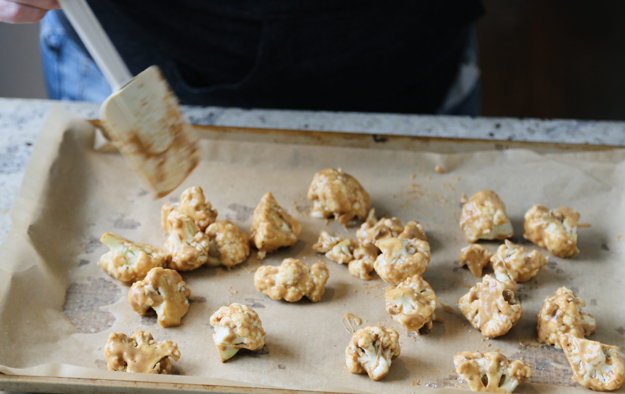 cauliflower florets on parchment lined sheet