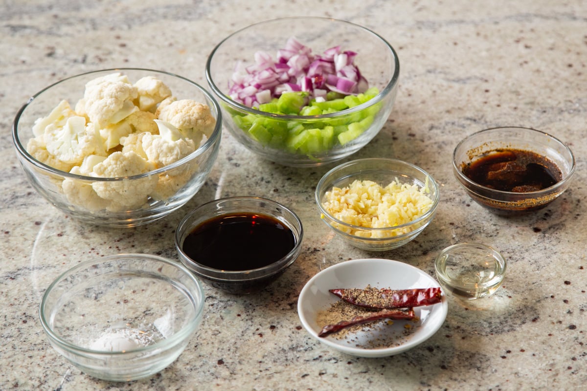 ingredients for black pepper cauliflower on a marble countertop
