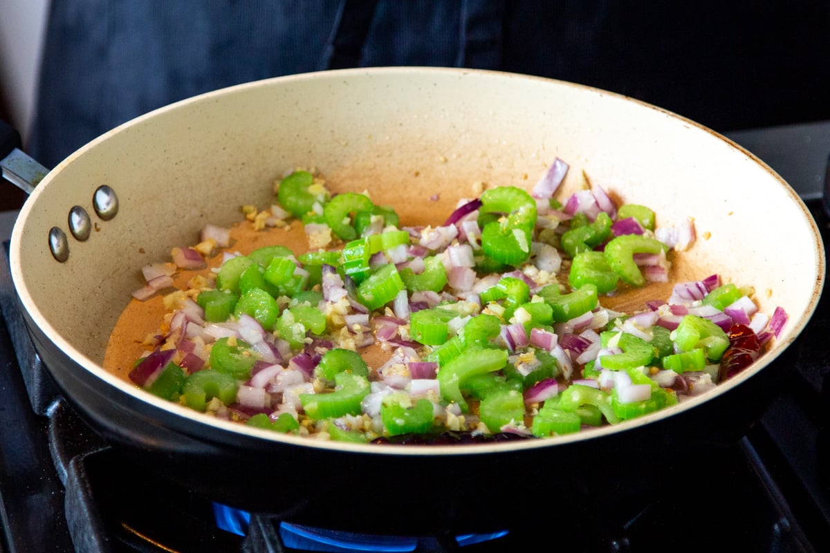 onion and celery sauteeing in a pan