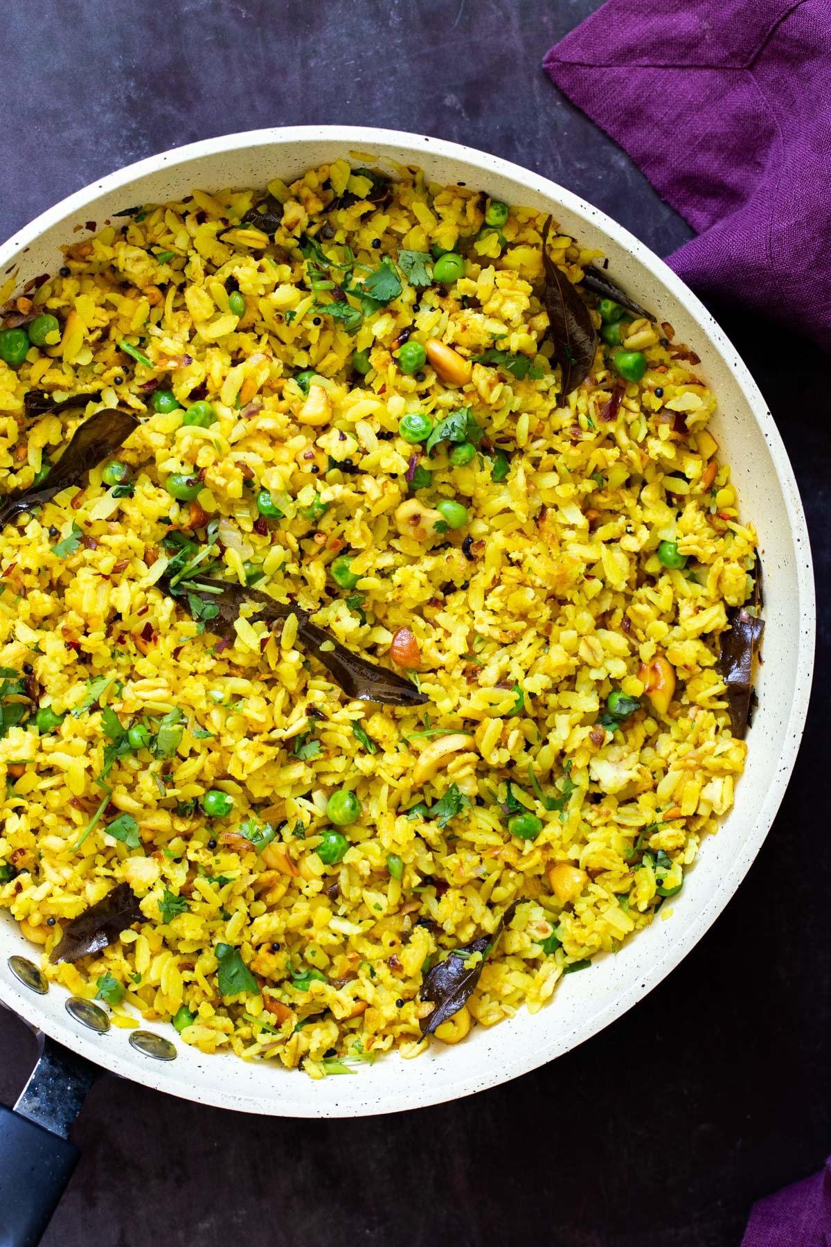 a sauteeing pan with Indian Poha with peas and spices