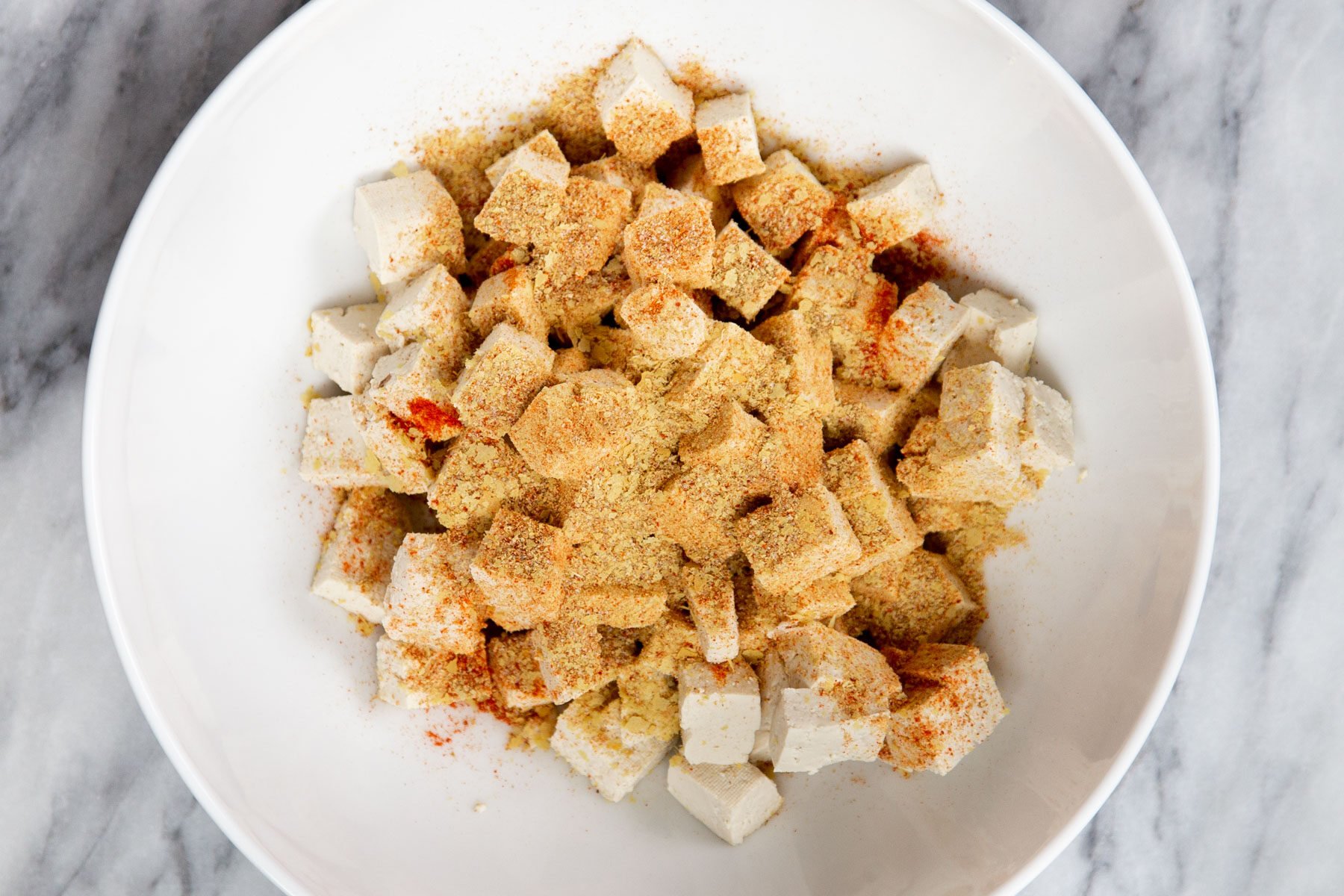 seasoned tofu cubes in a small bowl 