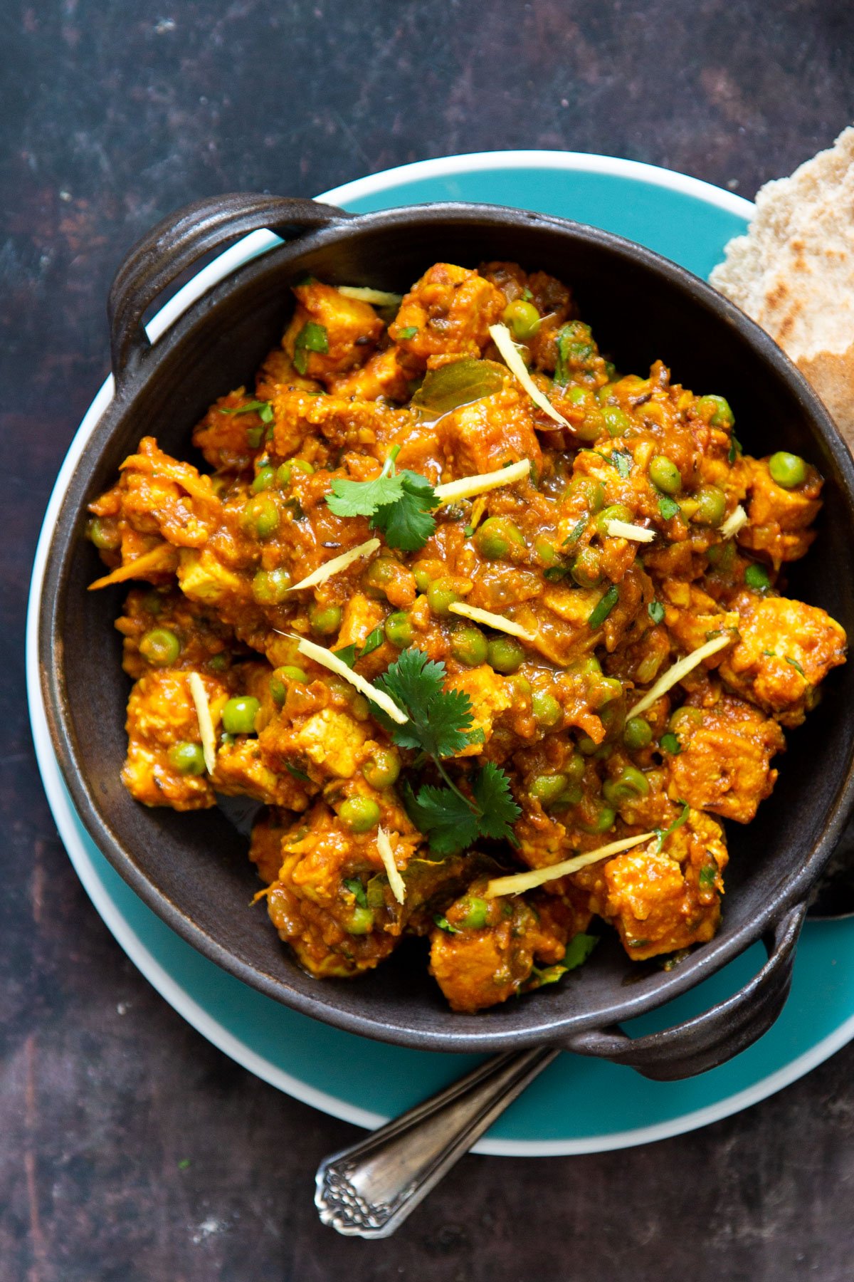 vegan matar tofu served in a small skillet with a side of flatbread 