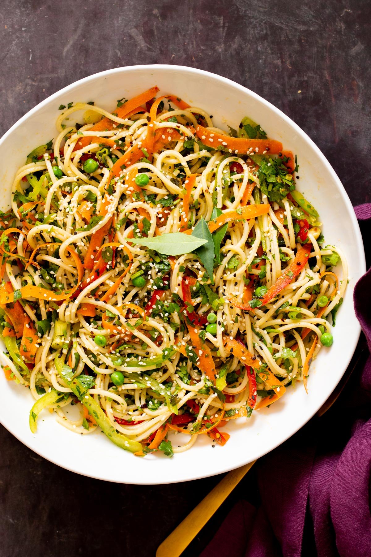 mustard chili oil pasta salad in a bowl sprinkled with sesame seeds