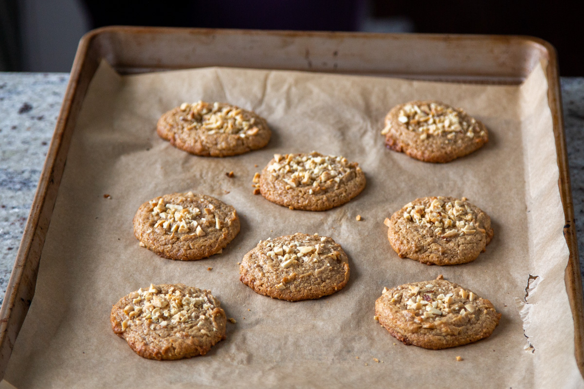 a baking sheet with freshly baked vegan no flour peanut butter cookies