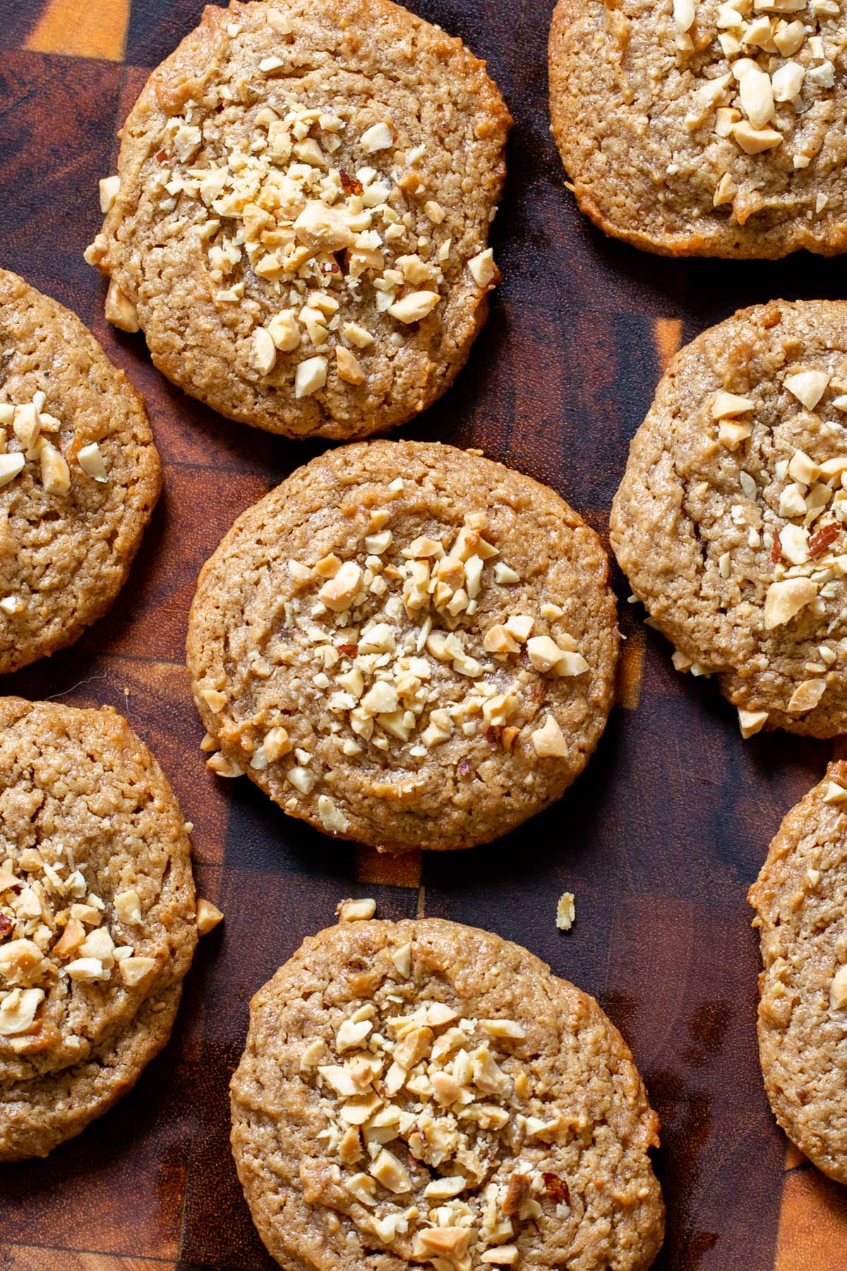 overhead shot of peanut butter cookies sprinkled with crushed peanuts