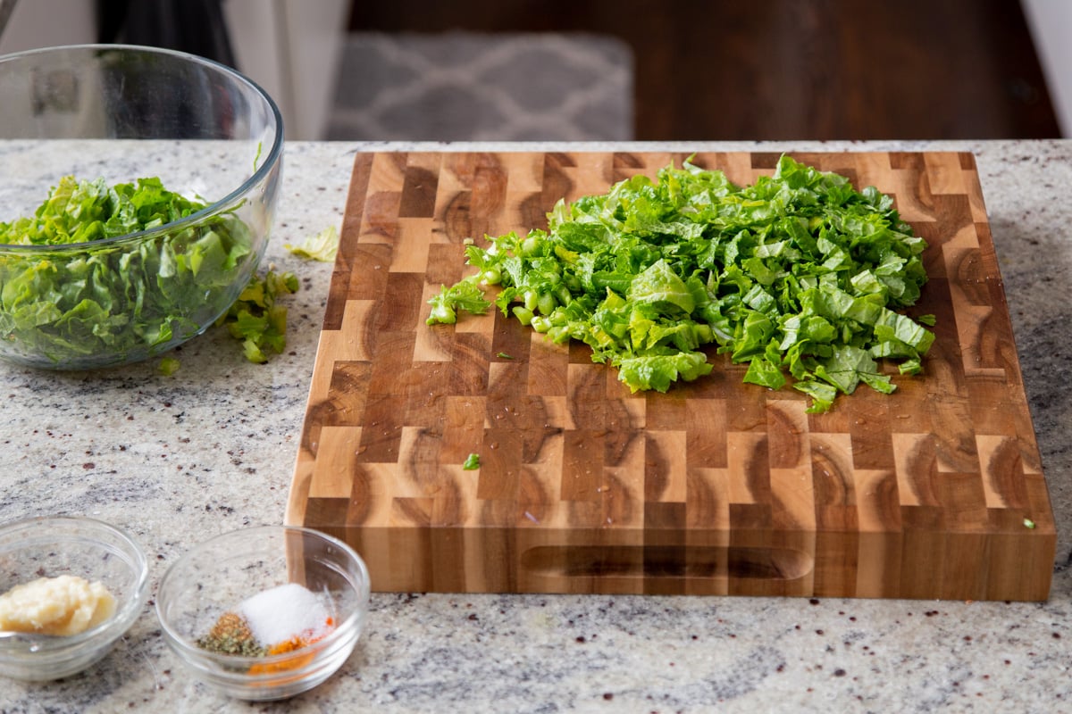 chopped mustard greens on a chopping board
