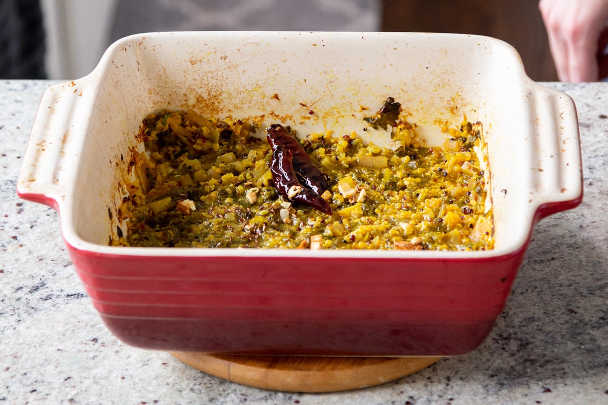 greens, chili and garlic in a red casserole dish