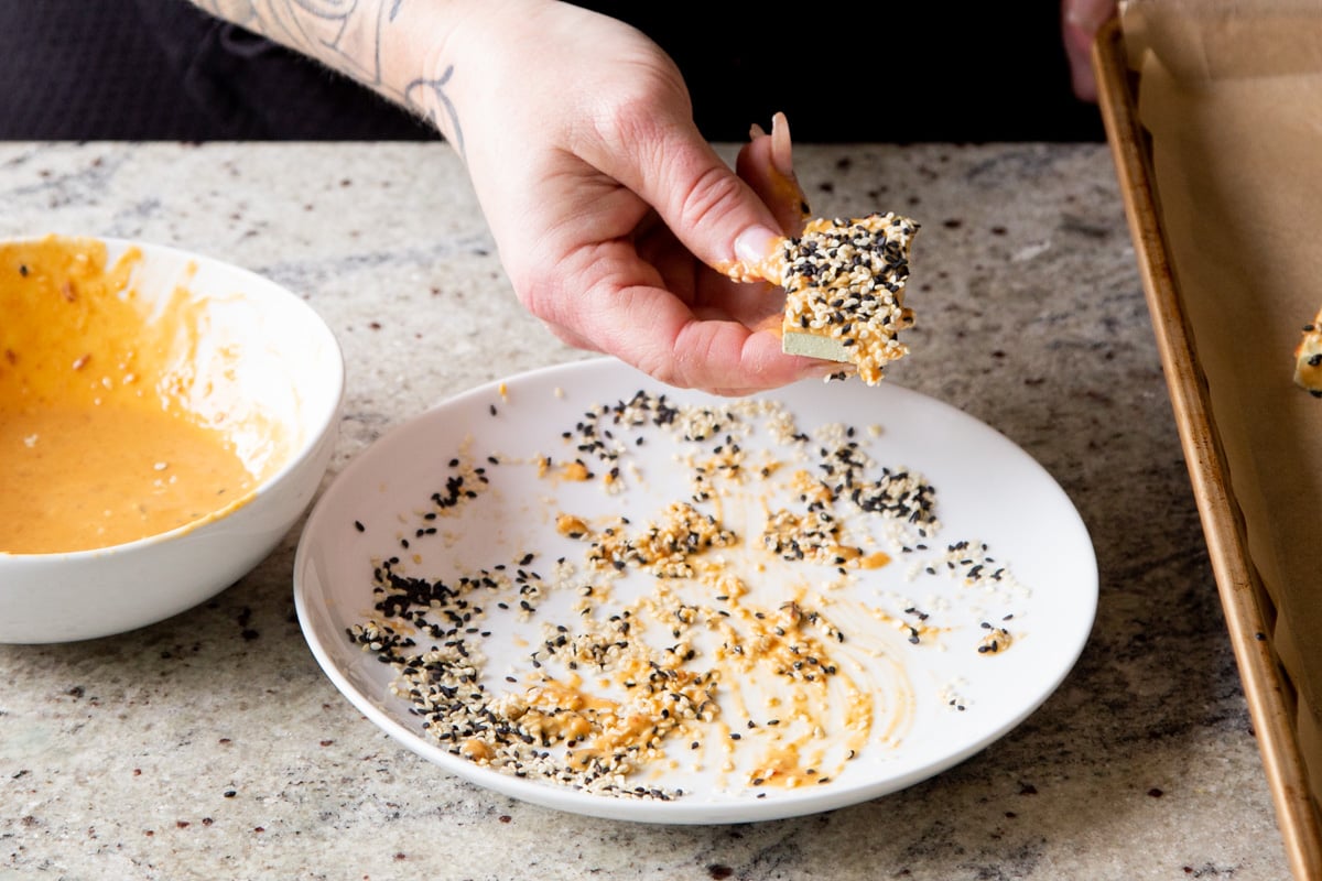 tofu cubes coated with peanut butter and sesame seeds