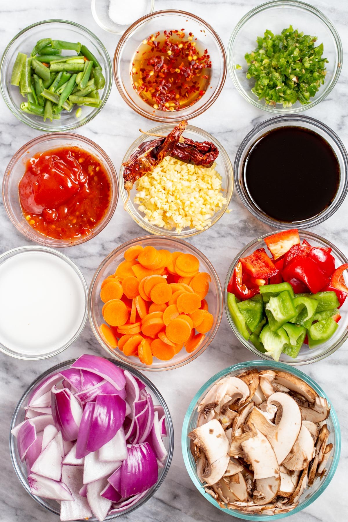 ingredients for veggies in hot garlic sauce on a marble countertop