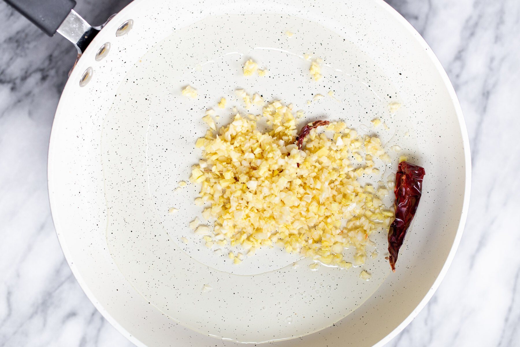 minced garlic and chili in a frying pan