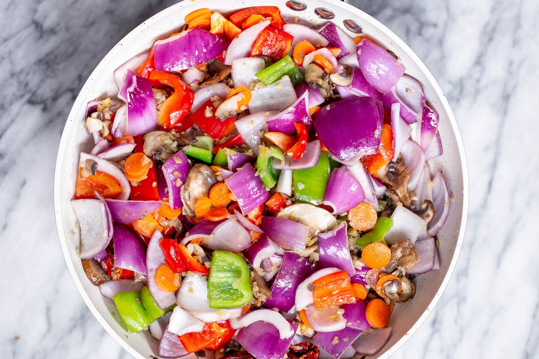 chopped veggies frying in a pan