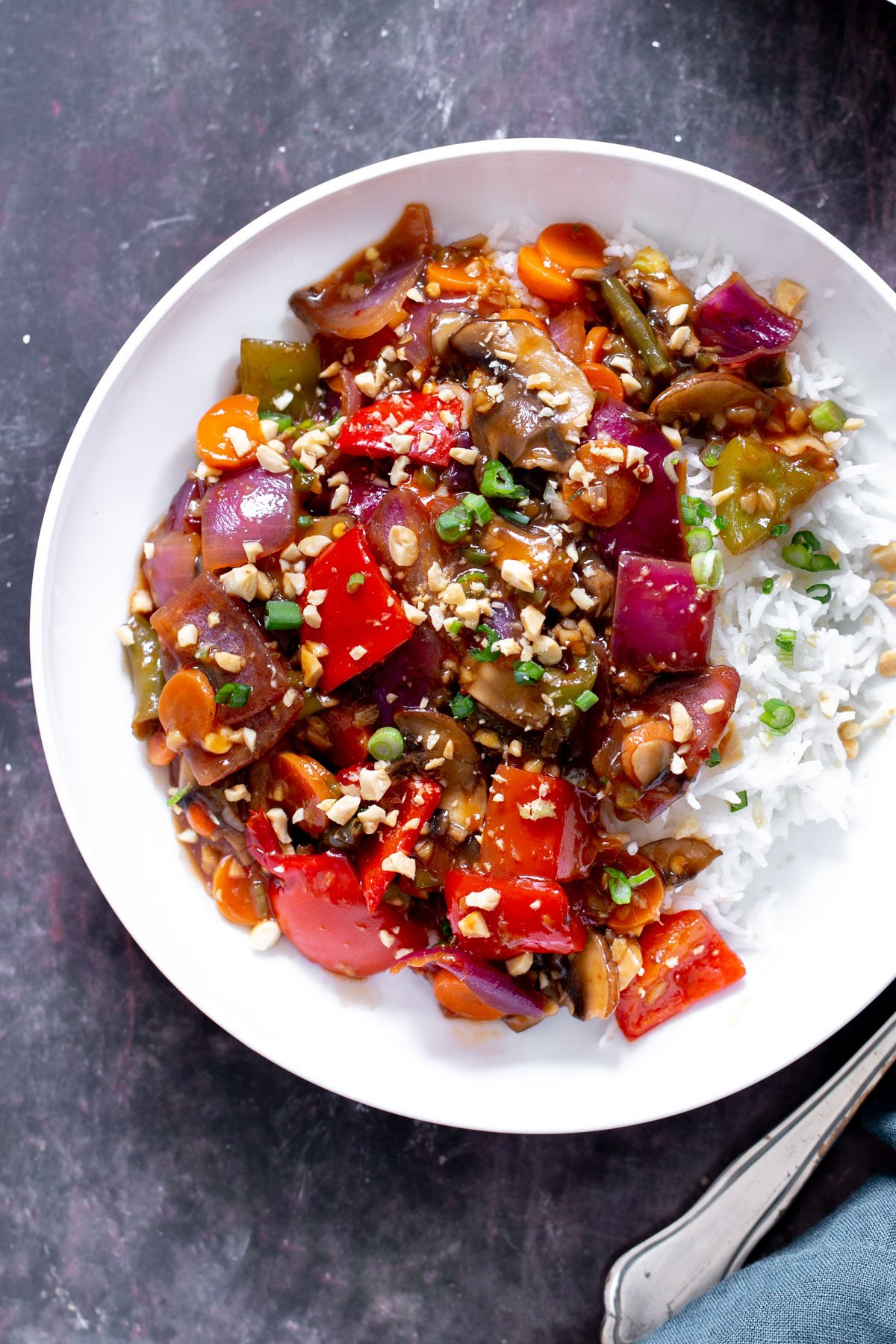 a plate of Indo Chinese Sweet & Spicy veggies served with rice