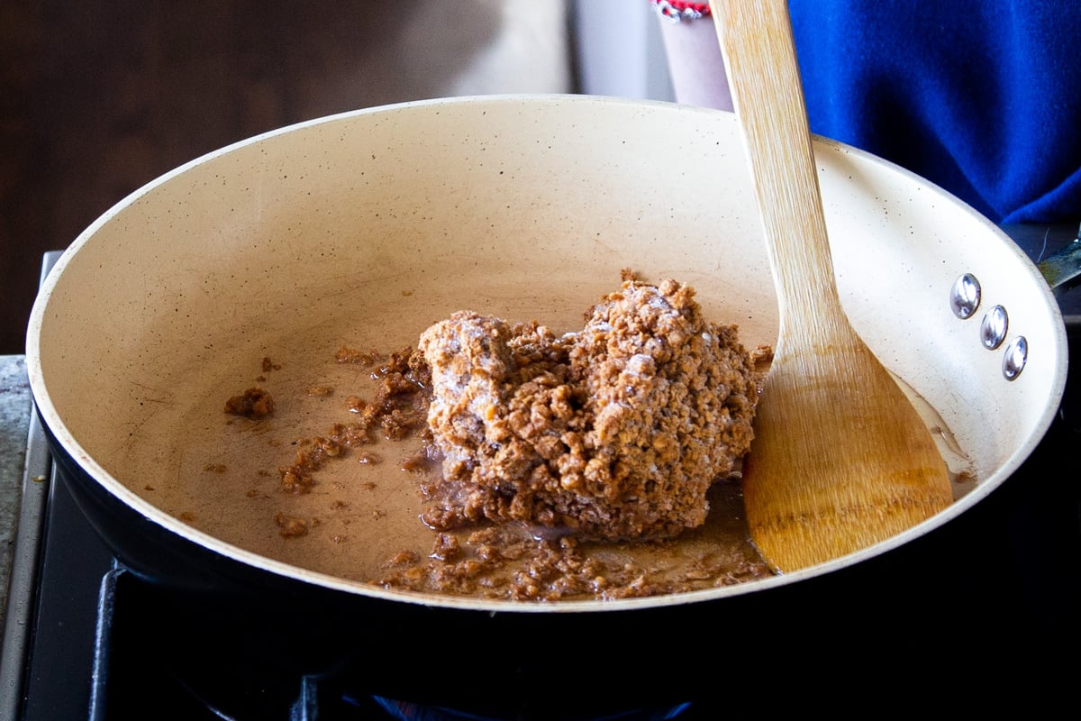 veggie crumbles being fried in a sauteeing pan