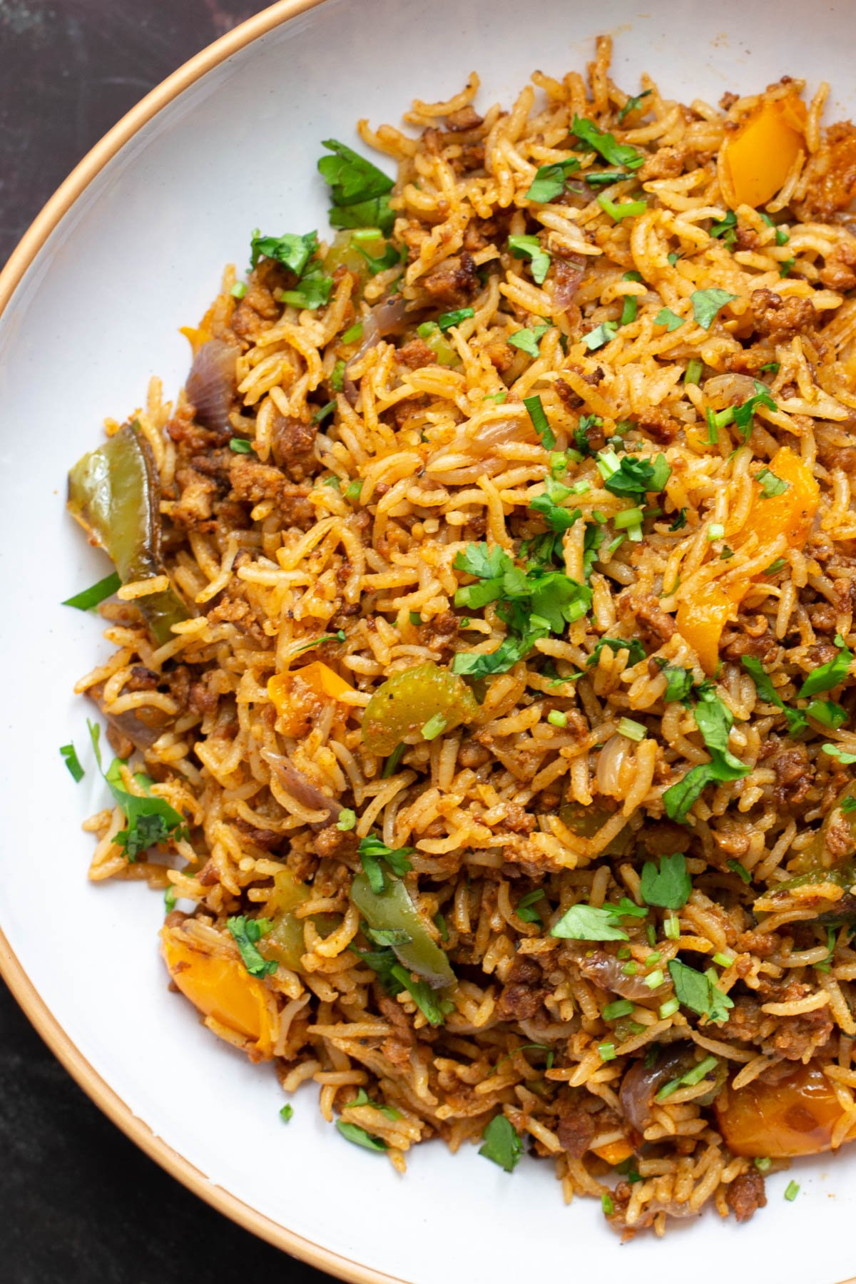 a plate of vegan cajun dirty rice sprinkled with chopped cilantro