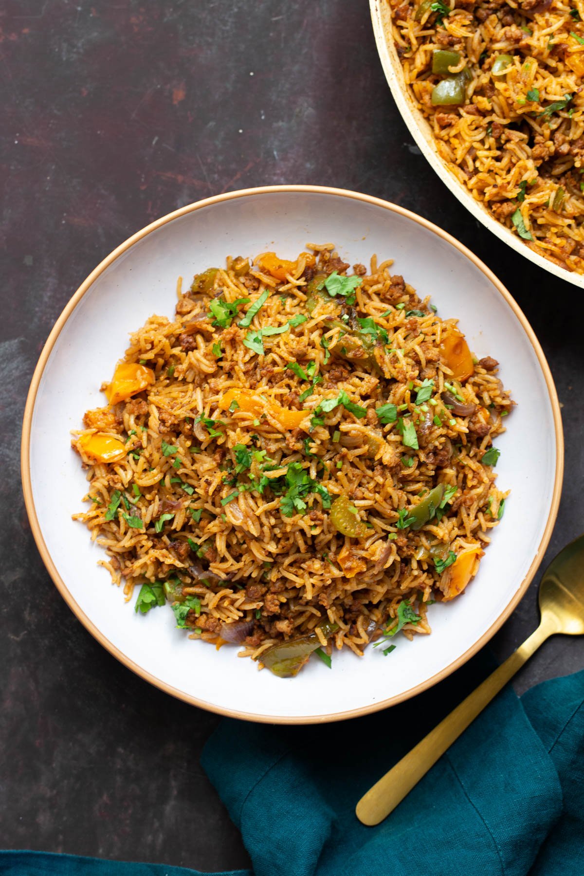 a plate of vegan cajun dirty rice with a golden fork on the side