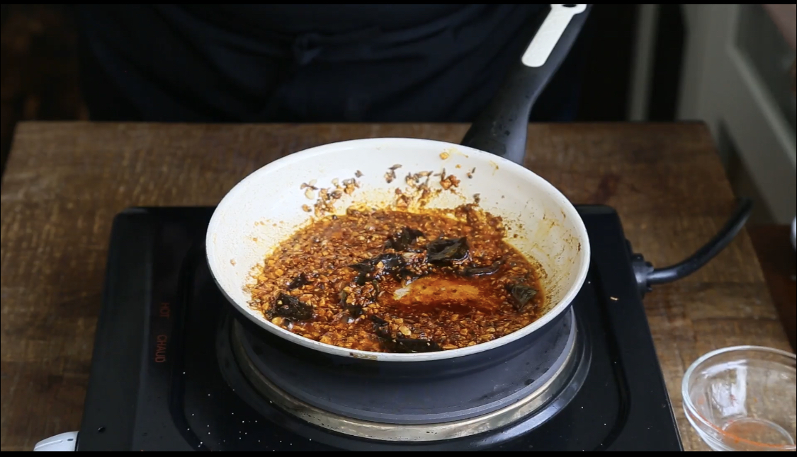 spices added to white pan for tempering for chataka dal