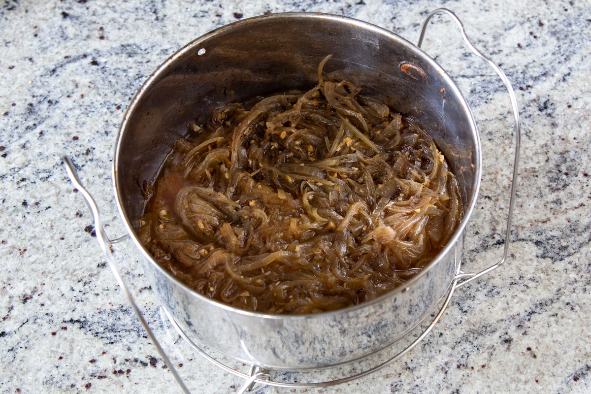 a silver pot with caramelized onions