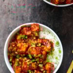 gochujang cauliflower wings in bowls with rice and green onions