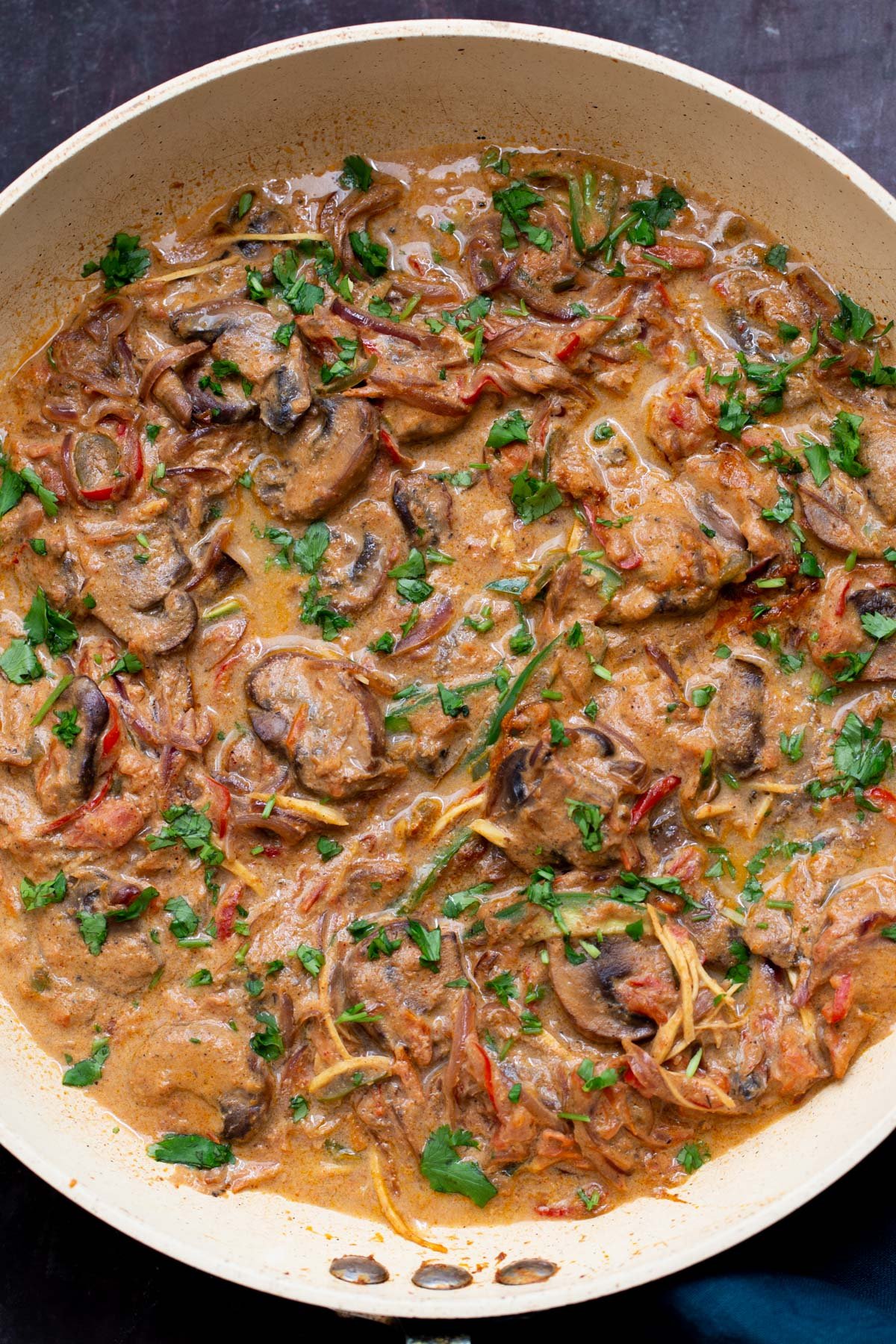 a sauteeing pan with vegan mushroom patiala in creamy gravy