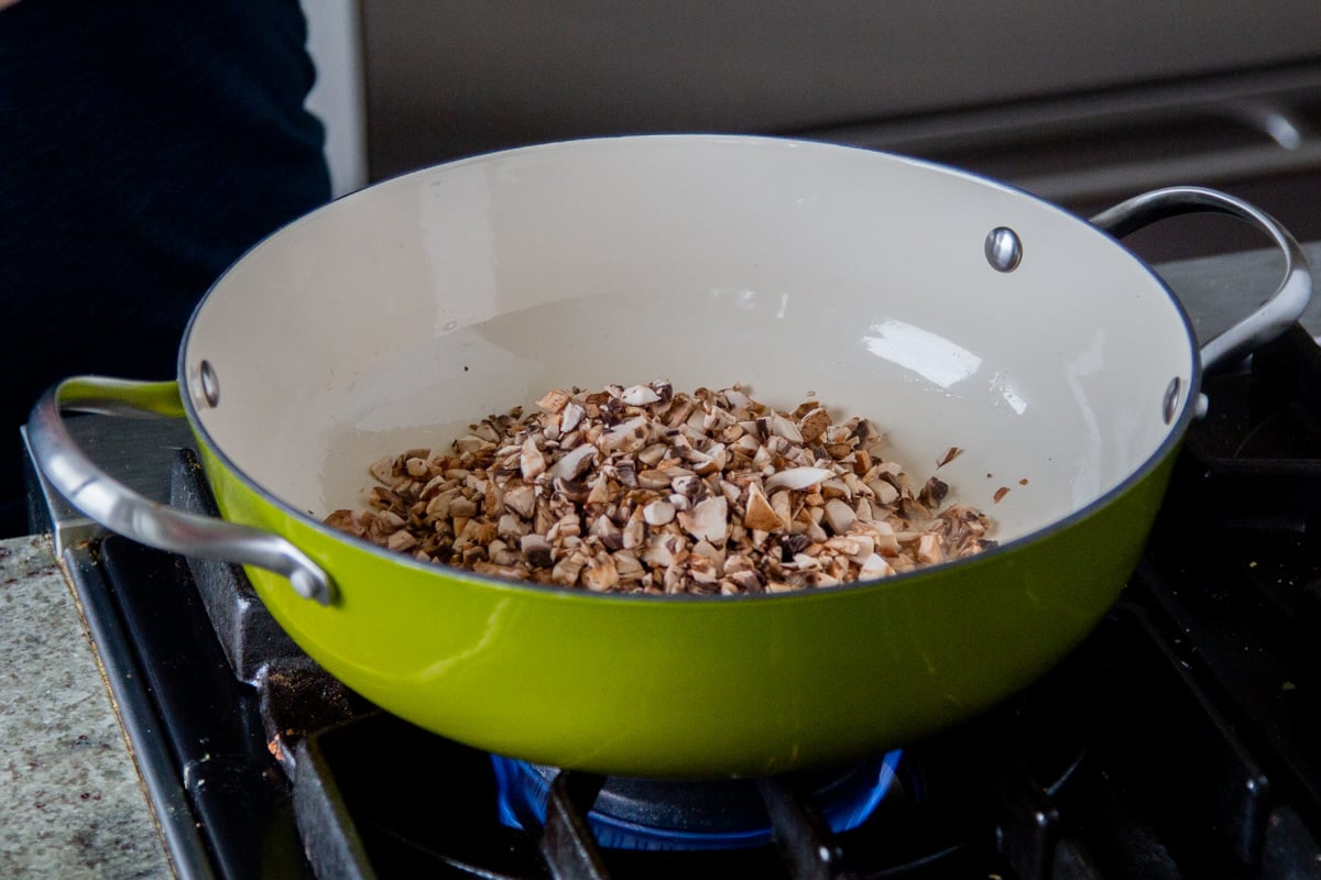 a sauteeing pan with chopped mushrooms