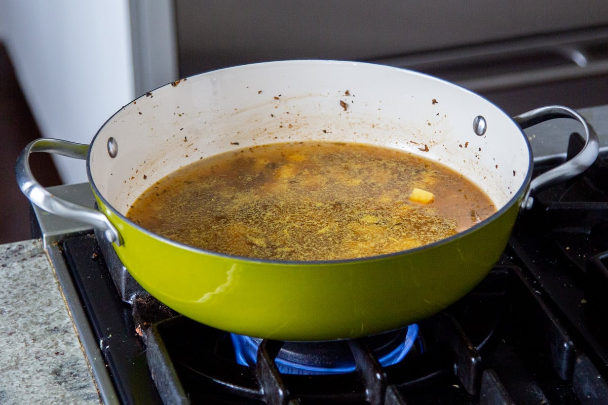 sausage and cubed potatoes simmering in a saucepan