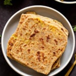 aloo paratha pilled up on a plate