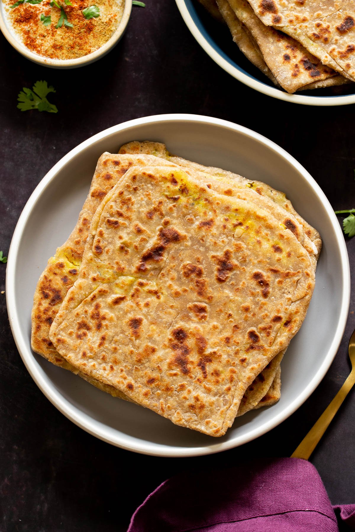 aloo paratha pilled up on a plate