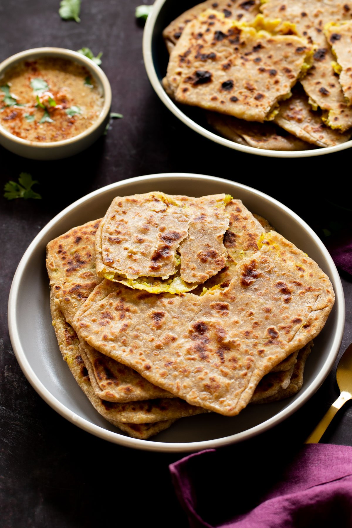 serving platters of aloo paratha with chutney for dipping