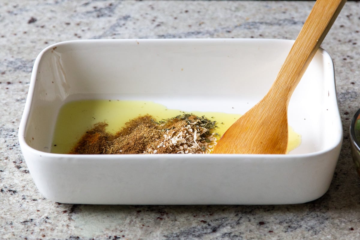 adding spices to the baking pan