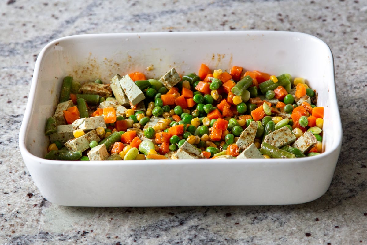 mixing veggies into the tofu and spices